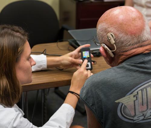 Dr. Nguyen working with CI client